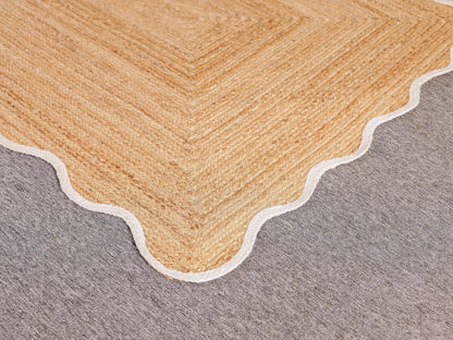 Close-up of a beige carpet border on a gray carpet